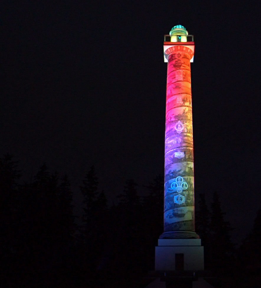 Astoria Column lit by colored LED lights at night